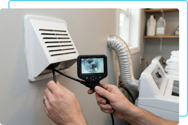 home inspector's hand holding a digital borescope inspection camera
